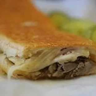 a meat sandwich with pickles