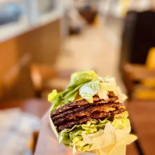 Lettuce-wrapped QUAD cheeseburger. Sans tomatoes, pickles or onions.