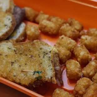 a sandwich and tater tots