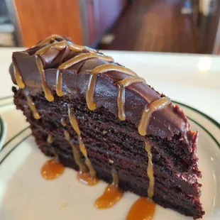 a slice of chocolate cake with caramel drizzle