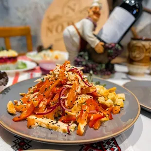 a plate of pasta and a bottle of wine