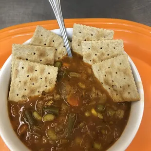 a bowl of soup and crackers