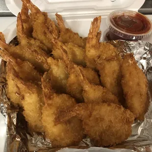 fried shrimp in a container with ketchup