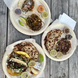 three plates of food on a wooden table