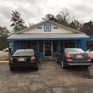 two cars parked in front of the restaurant