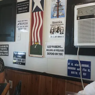 a man sitting at a table in front of an air conditioner