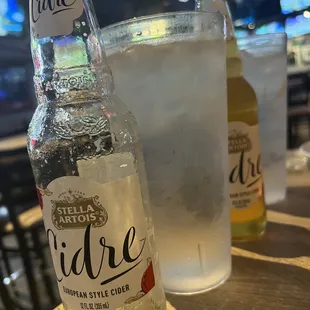 a bottle and a glass of ice water