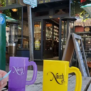 two coffee mugs on a picnic table