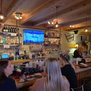 a group of people sitting at a bar