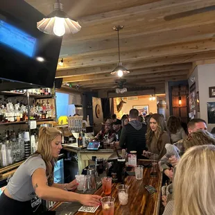 a group of people sitting at a bar