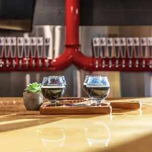 two glasses of wine on a bar