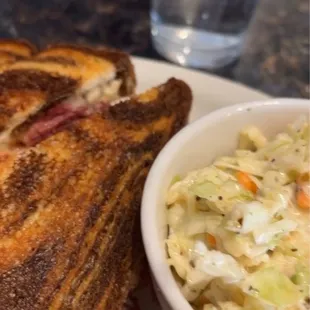 a grilled sandwich and coleslaw