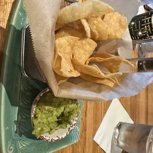 Happy hour cumin chips and guacamole