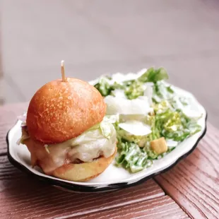 a burger and salad on a plate