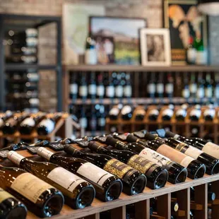 rows of wine bottles in a wine shop