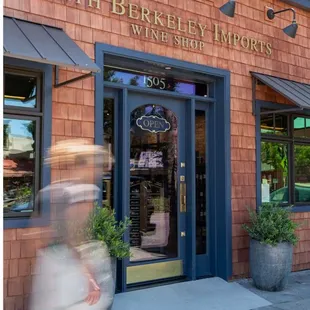 a blurry image of a woman walking in front of a store