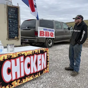 a man standing in front of a bbq