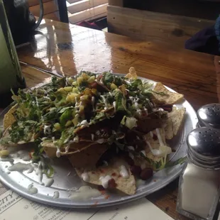 Veggie nachos with vegan chili, jalepeno ketchup, and pineapple salsa. Sweet, spicy, and delicious.