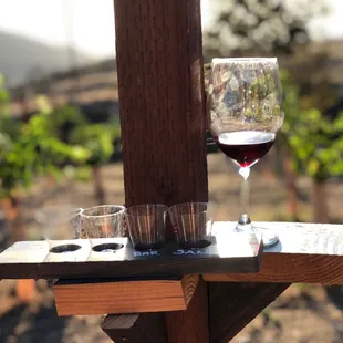 The tasting flight, enjoyed by the swings, cleverly equipped with ledges for your drinks.