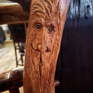 Carving in the railing that you would never notice next to the bar.