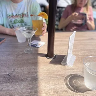 a woman sitting at a table with a glass of water