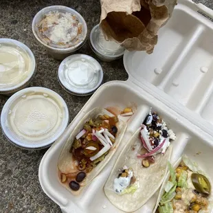 Spicy Athens Barbacoa, Veggie and chicken tacos. Queso and Mexican street corn with sides of sour cream.