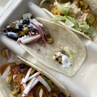two tacos in a styrofoam container