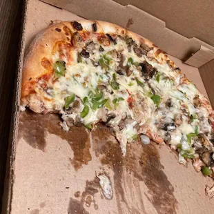 a half eaten pizza in a box