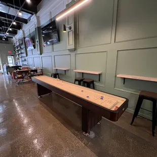 a shuffle table in the middle of the room