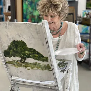 Patricia Triplett at work on a chair for the Lynn Institute Chairity Event.