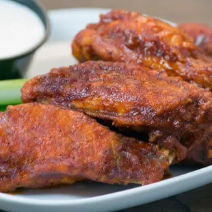 a plate of chicken wings and celery