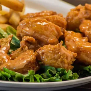 a plate of chicken wings and french fries