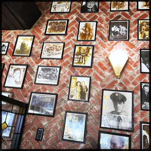 a wall full of framed photos