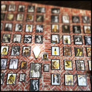 a brick wall with a lot of pictures