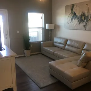 Living room area with back door. Only our 2 bedroom apartments come with a storage on the back patio.