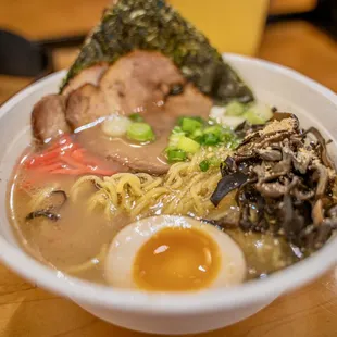 a bowl of ramen with meat and vegetables