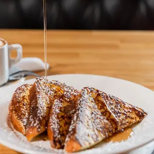 a plate of french toast and a cup of coffee