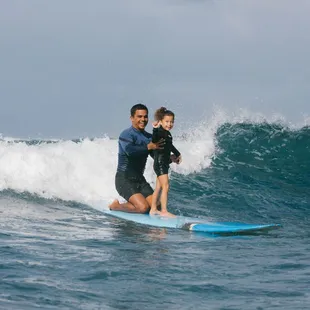 Tandem surfing on a beautiful day for 6 year old Mariela&apos;s first time surfing.