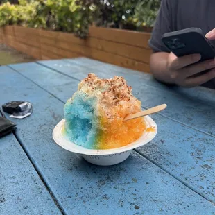 a bowl of ice cream and a cell phone