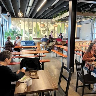 people sitting at tables in a restaurant