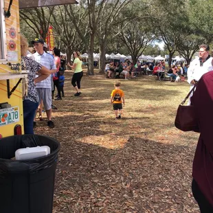 a young boy walking towards a food truck