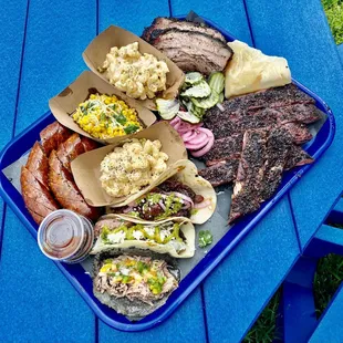 a platter of food on a blue picnic table