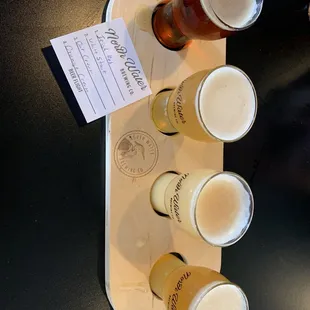 a flight of beers on a tray