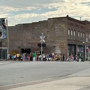 a crowd of people on a street corner
