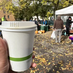 a hand holding a cup of coffee