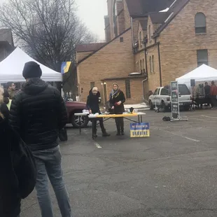 a group of people standing in a parking lot