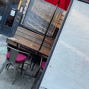 a table and chairs with a red umbrella