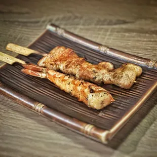 Pork belly and shrimp skewers.    They are yummy. But I would still skip. Very $$$