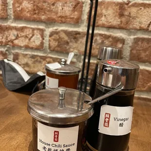 two jars of chili sauce on a table