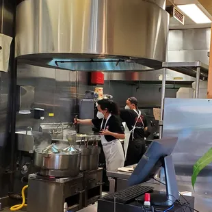 two cooks working in a commercial kitchen